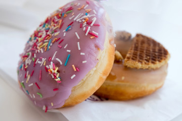 Colorful and delicious homemade donut cakes with strawberry and Belgian waffles taste