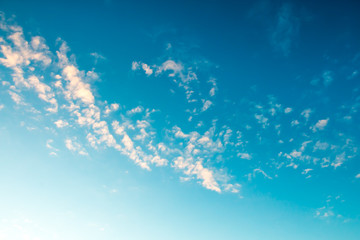 Scenic view at blue sky with clouds. Abstract nature background. Dramatic sky with fluffy clouds. Sunny day.