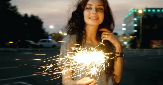 Beautiful Mixed Race Young Woman Celebrates With Sparklers Burning In Her Hands