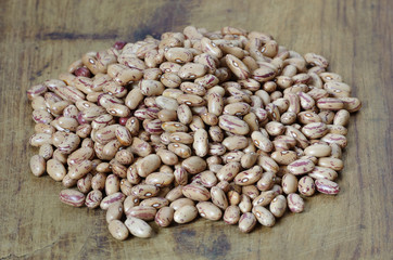 Pile of beans on a wooden board