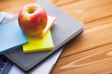 Laptop, white cup of coffee, cactus, snacks and notebook on the bright wooden background. Business, office, education, planning concept. Top view. Close up.