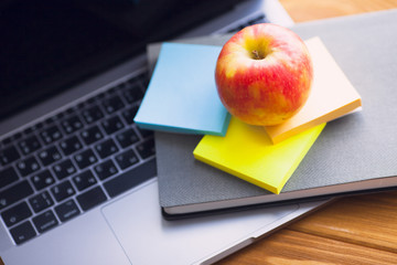 Laptop, white cup of coffee, cactus, snacks and notebook on the bright wooden background. Business, office, education, planning concept. Top view. Close up.