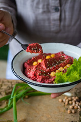 Pkhali ingredients: cilantro mixed with onion, garlic and green adjika, pomegranate, walnuts. Traditional Georgian food appetizer. Preparation process.