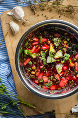 Cold soup Chrianteli with sour cherry or blackberry juice. Georgian traditional summer food with garlic, green herbs, cucumbers. Raw vegan vegetarian healthy food.