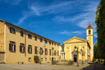 Fototapeta na wymiar Bagnoregio, Italy - Annunciation Church and Saint Augustin statue in historic center of old town quarter at Piazza Sant’Agostino square