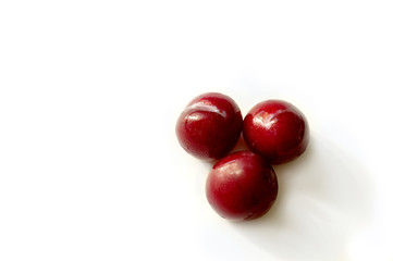 Red plum bright delicious juicy on a white background