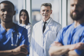 Doctor in White Uniform Standing in Hospital.