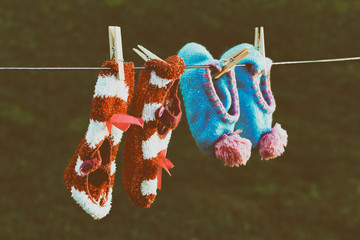 Womens soft and comfortable slippers on clothes line. Faded hip look.