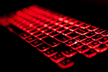 Gaming laptop keyboard red backlight with selective fockus.