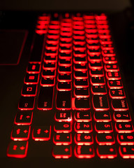 Gaming laptop keyboard red backlight with selective fockus.