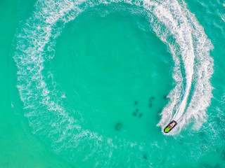 People are playing jet ski at sea during the holidays. Aerial view and top view.