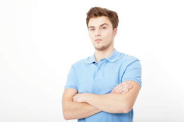 Smiling young man portrait isolated on white background. Copy space. Mock up. Handsome guy. Summer shirt clothes. Crossed arms