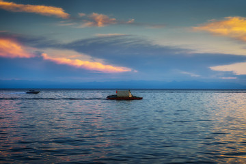 Summer landscape with a view of the floating raft on lake Baikal