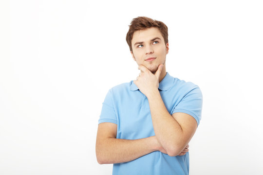 Thinking young man portrait isolated on white background. Copy space. Mock up. Handsome guy. Summer shirt clothes. Crossed arms