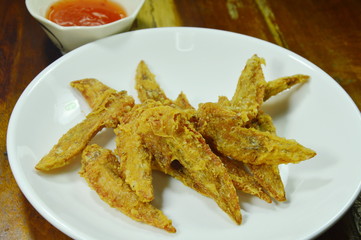crispy fried chicken wing on white plate dipping with spicy sauce