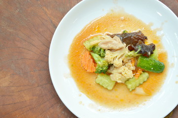 stir fried mixed vegetable with pork in sweet and sour sauce on white plate