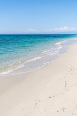 Fototapeta na wymiar Beautiful empty sandy beach and turquoise sea
