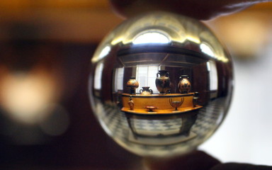A picture of a glass ball in a museum of antiquity.