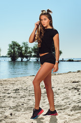 the athlete on the beach posing. blonde girl with big eyes posing