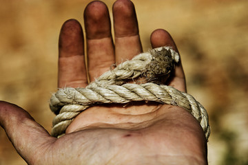 A man's hand is rewound with a rope