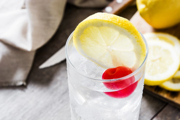Classic Tom Collins cocktail on wooden table.