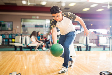 Boy Practicing His Swing At A Bowling Alley