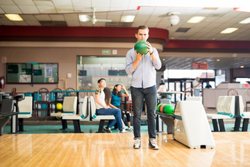 Teenage Boy Ready To Go Bowling At Alley In Club