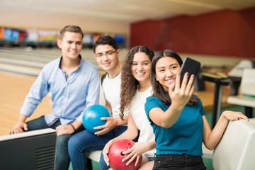 Friends Taking Selfie On Mobile Phone In Bowling Club