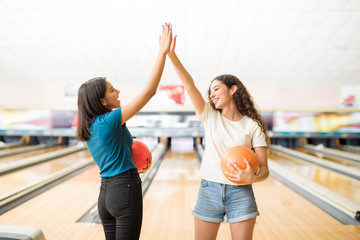 Girls Giving High-Five Before Starting Bowling Game