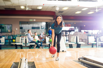 Teenage Girl Throwing Ball While Training For Bowling