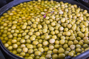 A lot of fresh green olives in a bowl