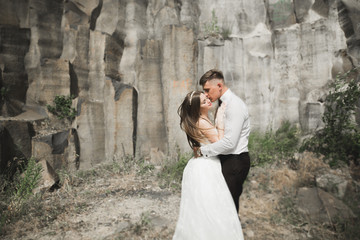 beautiful wedding couple in the mountains with rocks