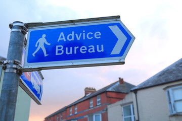 Advice Bureau sign on the street of Axminster in Devon