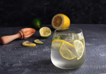 Summer citrus lemonade Alcohol cocktail Gin tonic with squeezed lemon and lemon reamer or juicer...
