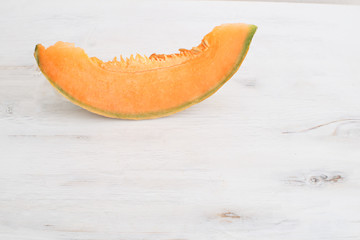 Summer harvest concept Fresh organic healthy fruit Sliced melon on white wooden background Copy space 