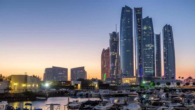 Al Bateen marina Abu Dhabi day to night timelapse with modern skyscrapers on background