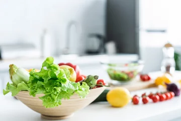 Zelfklevend Fotobehang close-up view of bowl with fresh healthy vegetables on kitchen table © LIGHTFIELD STUDIOS