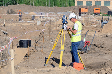 The surveyor performs topographic survey of the area for the cadastre