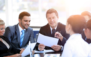 businessman and his business team discussing working papers.