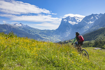 Fototapeta premium nice and ever young senior woman riding her e-mountainbike in Jungfrauregion,Switzerland, alps