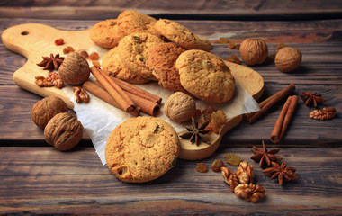 Homemade pastries with spices, nuts and raisins on a wooden table. Close-up. Christmas. A fragrant gift of handmade. Traditions.
