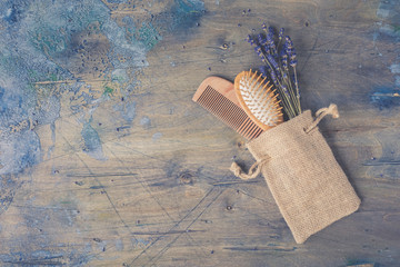 Wooden Scalp and Massage brush and hair comb with natural lavender on the rustic background