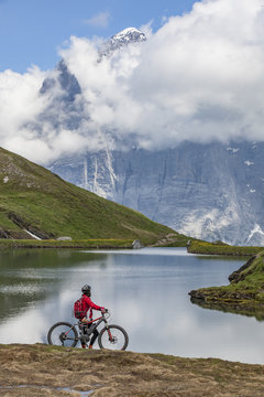 nice and ever young senior woman riding her e-mountainbike below the Eiger northface, Jungfrauregion, Switzerland © Uwe