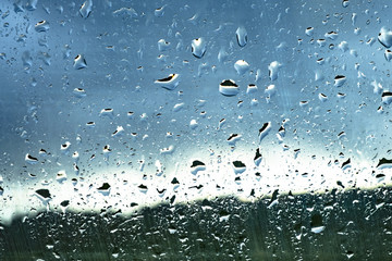 Drops on glass against the sky