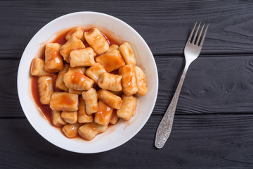 Homemade potatoes gnocchi with tomato sauce .