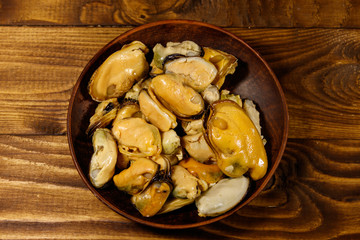 Marinated mussels on wooden table