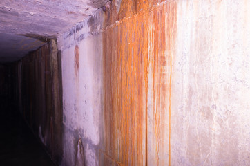 The wall is flooded with rust. The walls are grim and gloomy.