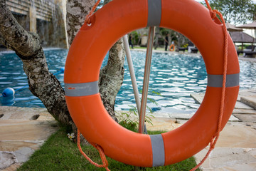 Marine lifebuoy on fence, near swimming pool