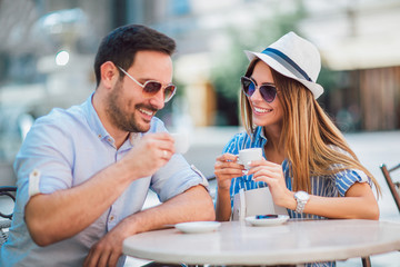 Beautiful loving couple sitting in a cafe enjoying in coffee and conversation