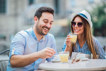 Beautiful loving couple sitting in a cafe enjoying in coffee and conversation